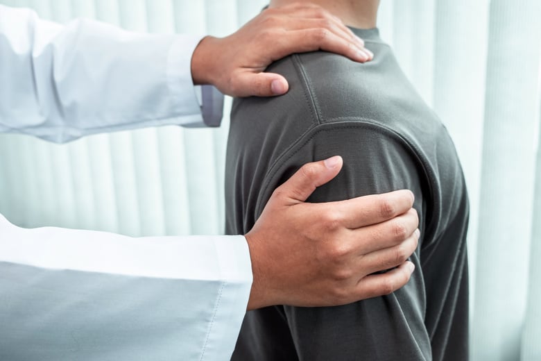 Physiotherapist Treating His Patient's Shoulder 